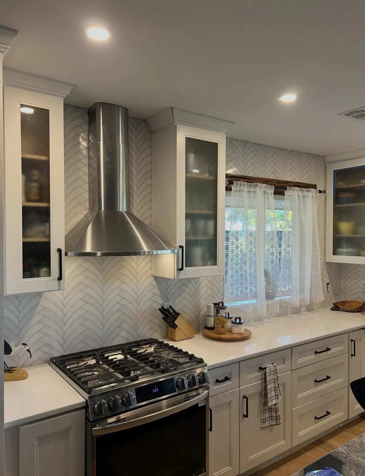 Wide kitchen view with chevron tile backsplash