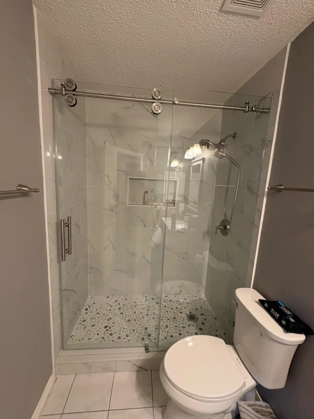 Custom tile shower with accent niche and porcelain wall tile in Arlington