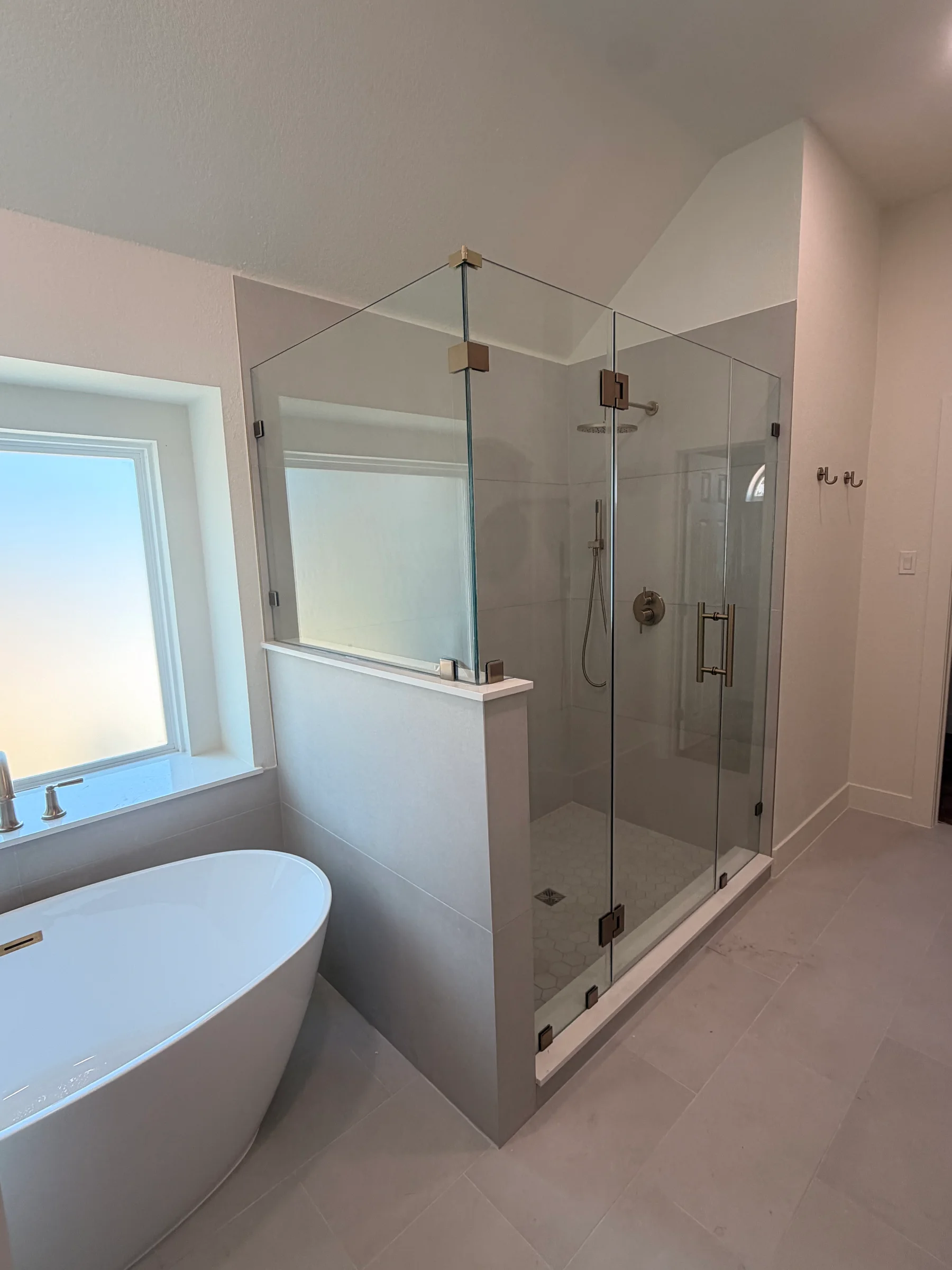 Finished bathroom with freestanding tub and glass shower