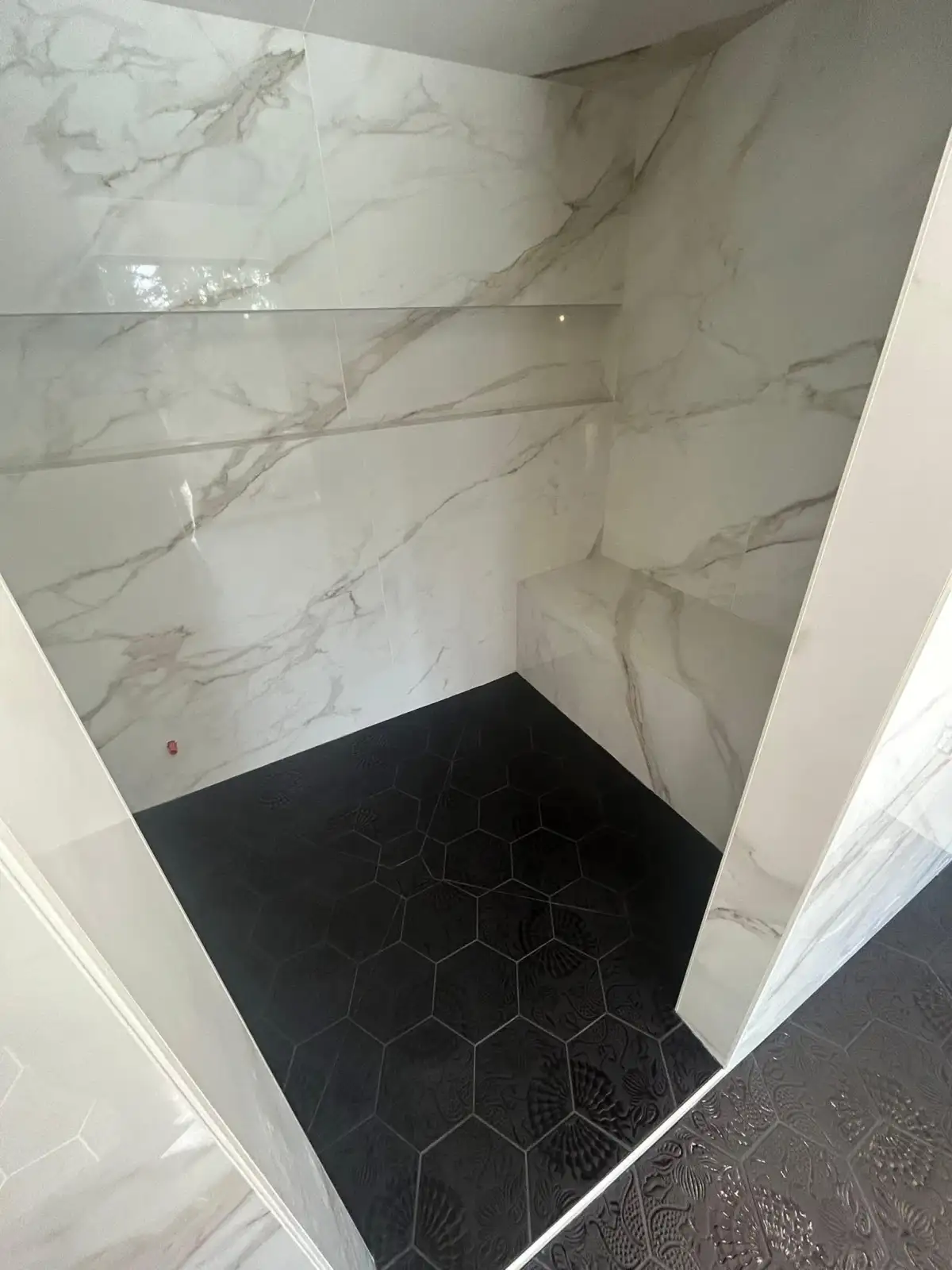 Large-format porcelain floor tile installed in Arlington bathroom