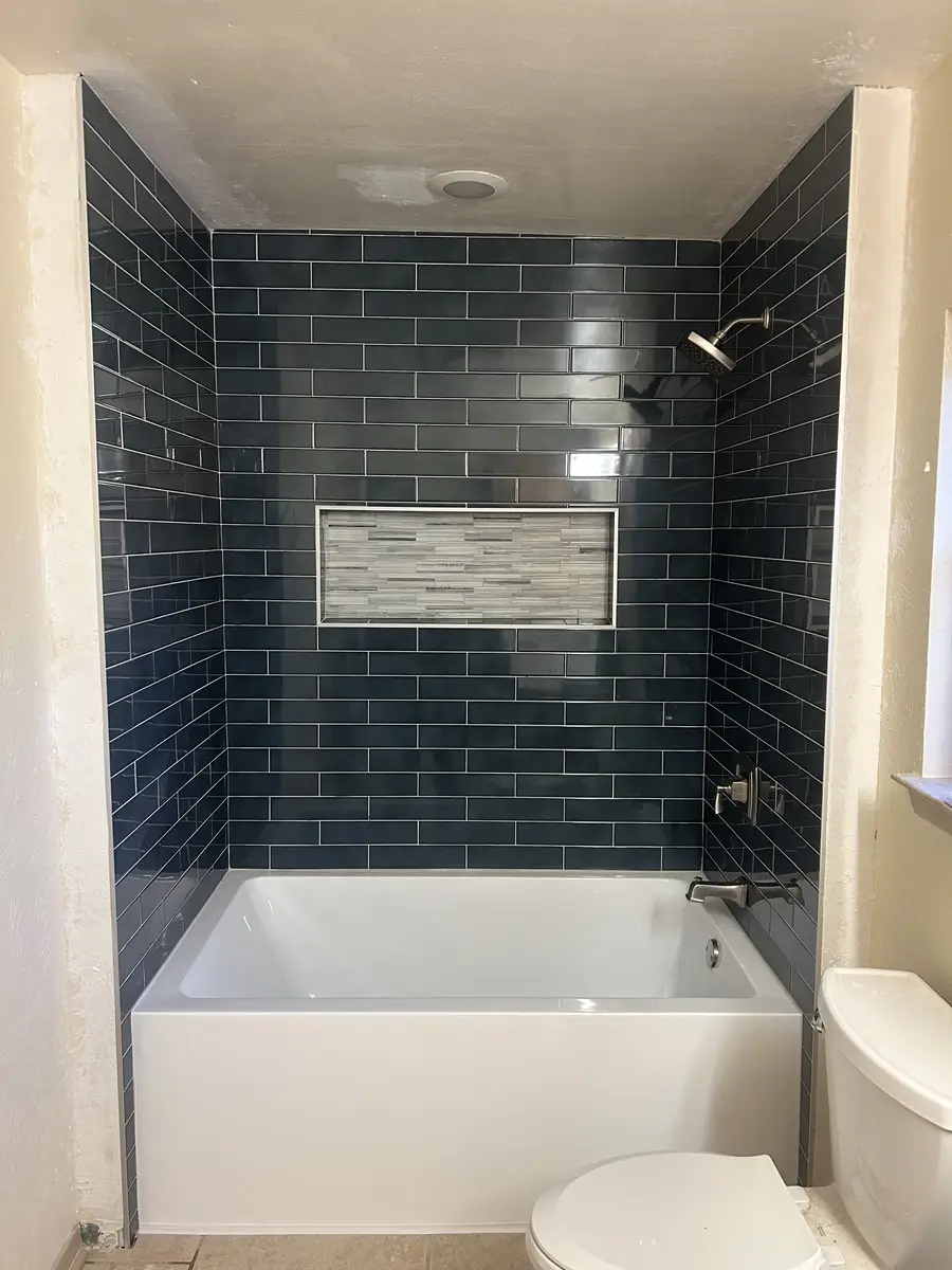 Bathroom tile detail with clean grout joints and precise finish work