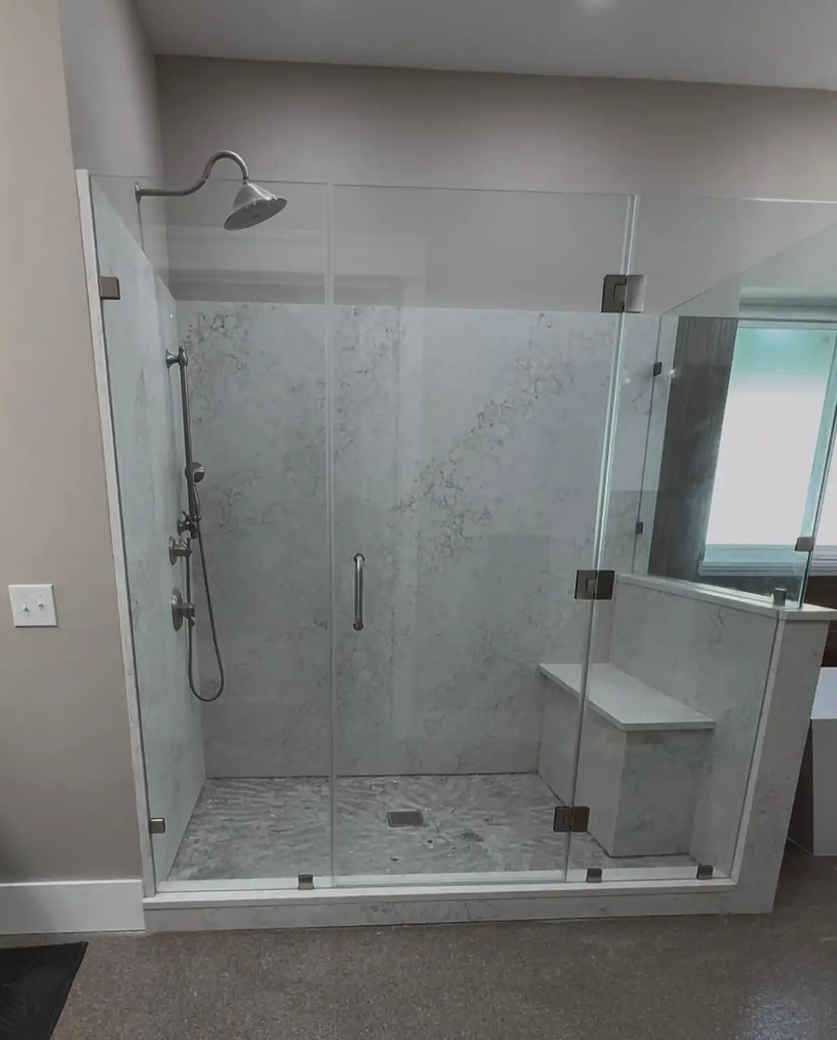 Walk-in shower installation with glass enclosure and built-in niche